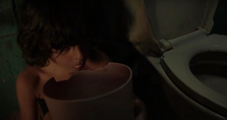 A young boy sits next to a toilet in the first Crimes of the Future trailer