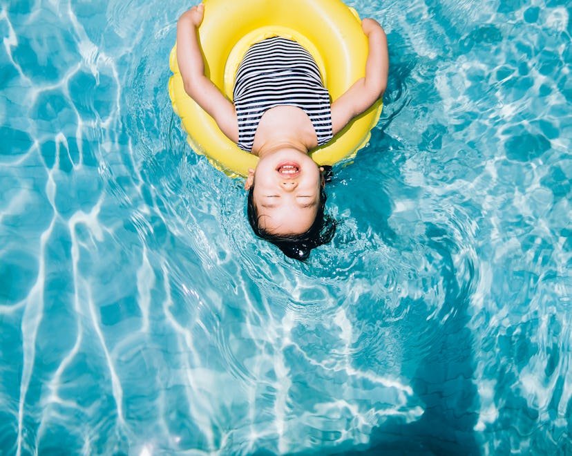 This young Asian girl floating on clear blue water in a yellow inner tube should be named after the ...