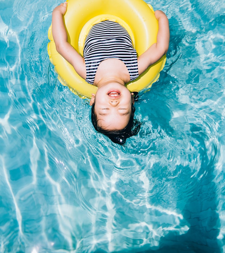 This young Asian girl floating on clear blue water in a yellow inner tube should be named after the ...