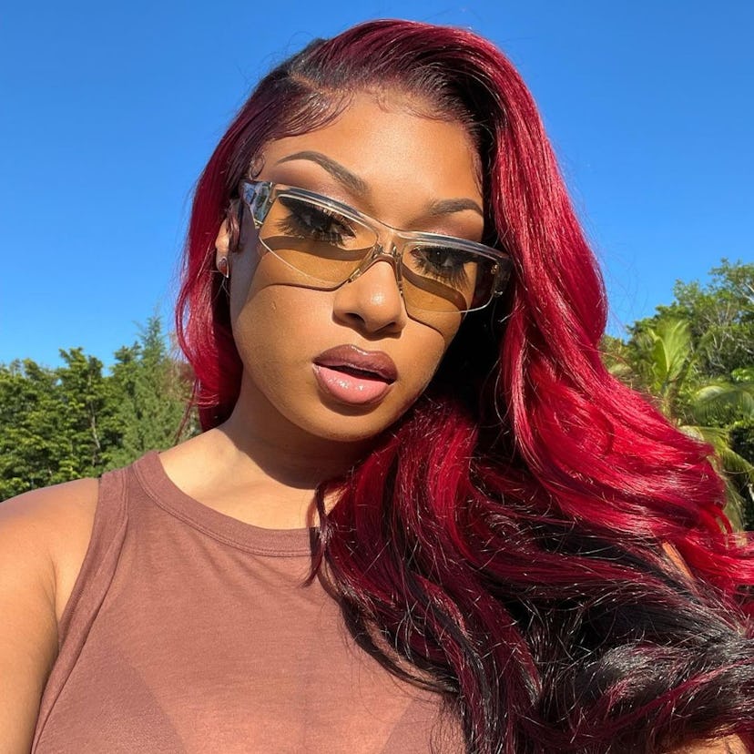 Megan Thee Stallion poses with two-toned red hair.