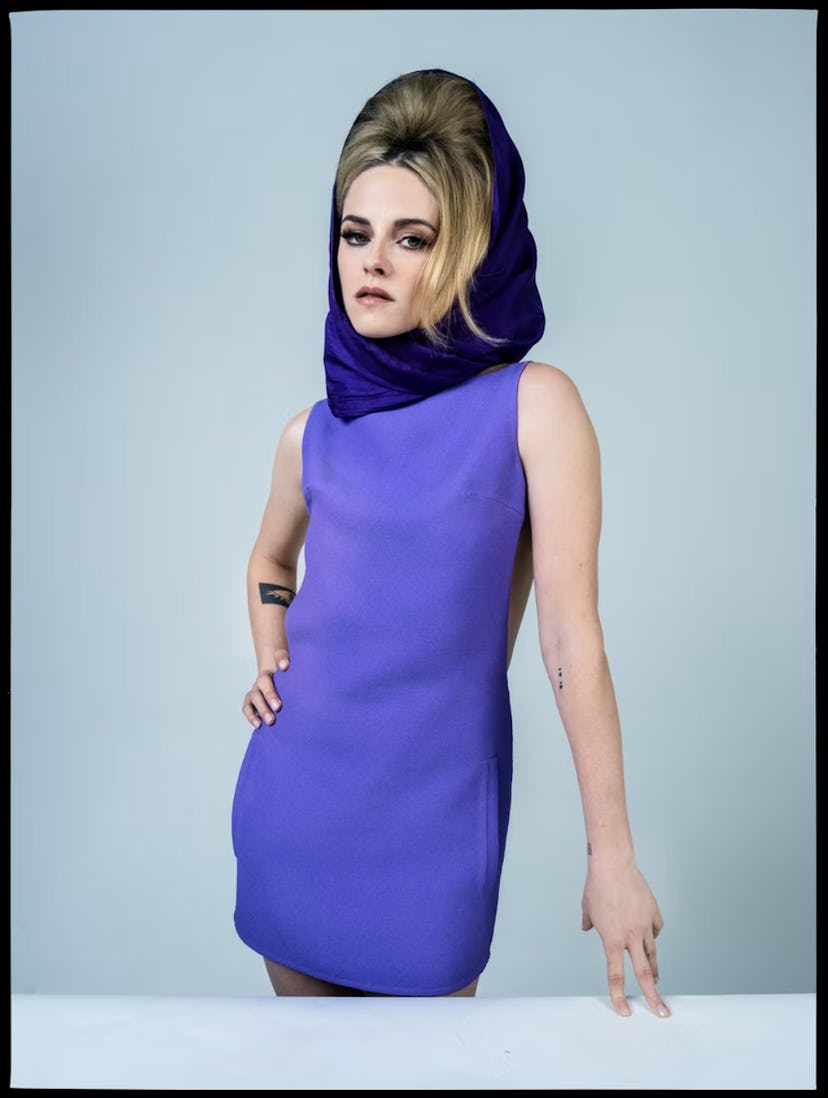 Kristen Stewart wearing a purple dress and a matching head scarf