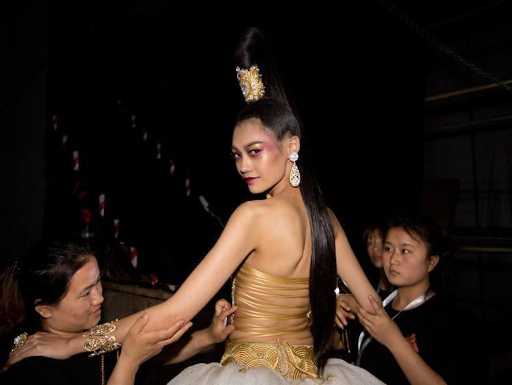 a model backstage wearing a guo pei gown