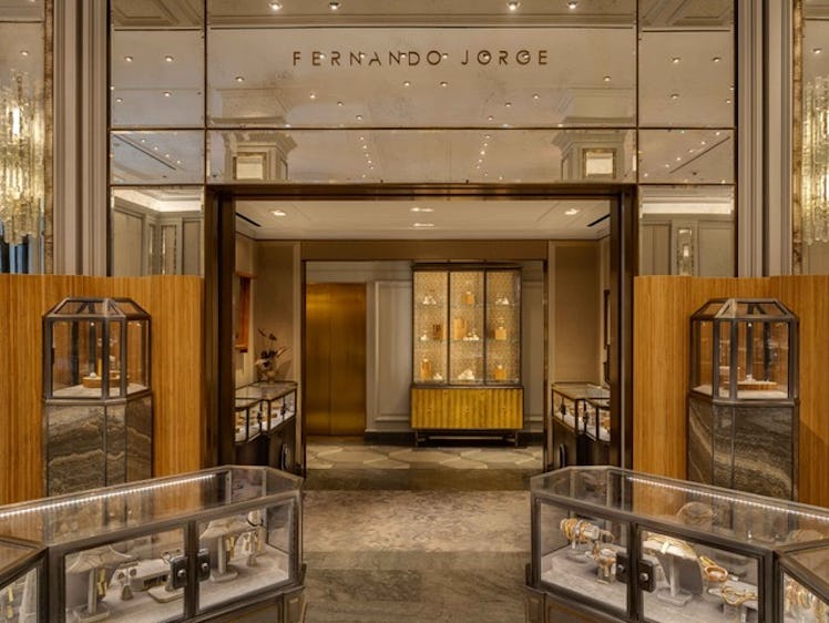 Fernando Jorge store in Bergdorf Goodman with light brown walls, glass display areas for the pieces ...