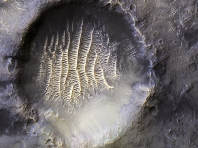 a crater showing ridges that look like the surface of a cantelope