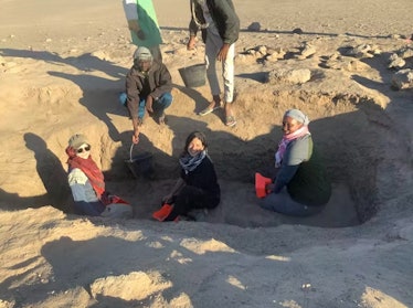 Research team members excavating a tumulus burial structure.