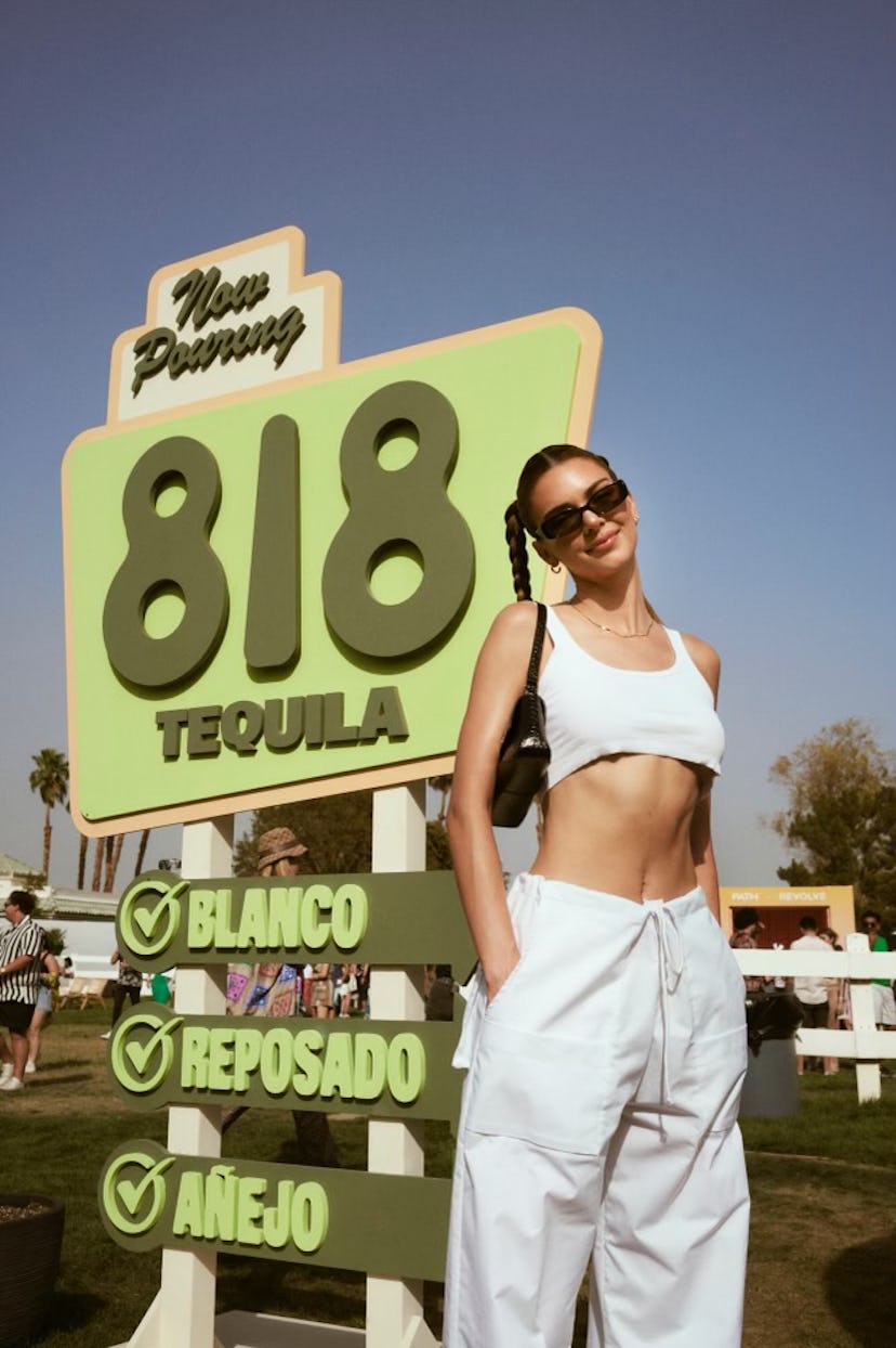 Kendall Jenner in white crop top and wide-leg pants at Revolve event at Coachella 2022
