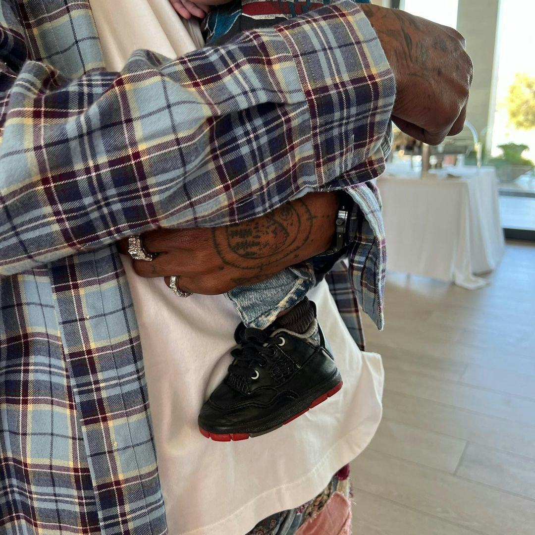 Travis Scott holding his second baby he had with Kylie Jenner.