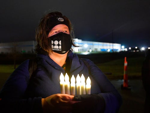 Marla Chassels holds battery-powered candles, representing each one of the Amazon employees killed d...