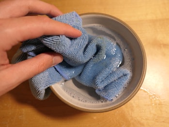 A microfiber cloth dipped in soapy water.