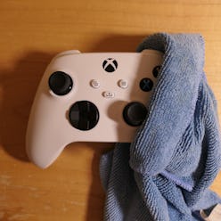 Cleaning Xbox Series Controller wrapped in a microfiber cloth