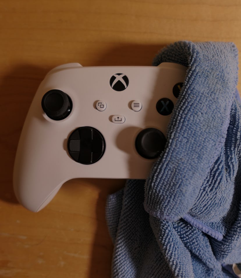 Cleaning Xbox Series Controller wrapped in a microfiber cloth