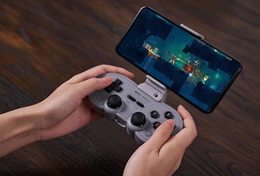 A person using an 8BitDo SN30