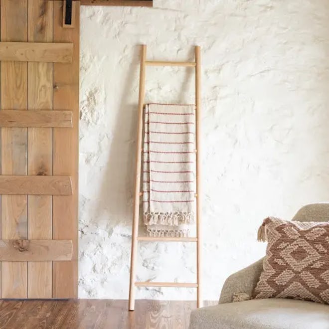 Decorative neutral wooden ladder for making a room look taller