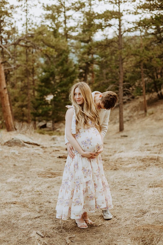 Laura with her husband, wearing a Zimmermann dress at eight months pregnant 