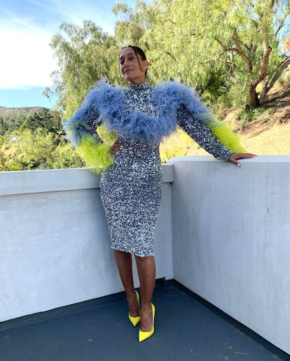 Tracee Ellis Ross wearing a sequin dress with dramatic feathered sleeves.