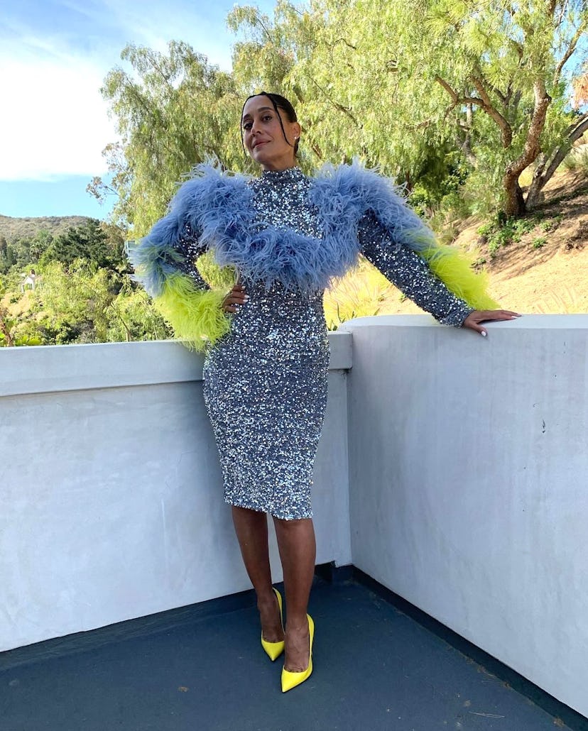 Tracee Ellis Ross wearing a sequin dress with dramatic feathered sleeves.