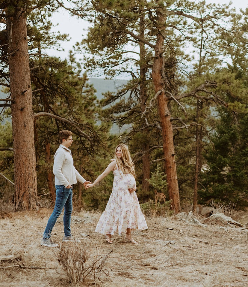 Laura with her husband, wearing a Zimmermann dress at eight months pregnant