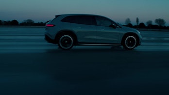 Mercedes-Benz EQS SUV driving on road promo image
