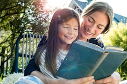 mother and daughter reading outdoors is a great way to appreciate earth day poems