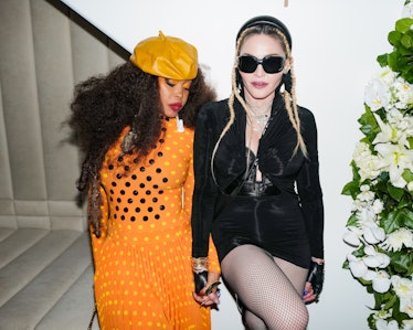 Erykah Badu and Madonna holding hands