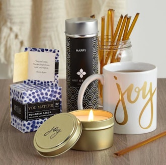 Tea kit with mug, honey sticks, candle, tea, and cards