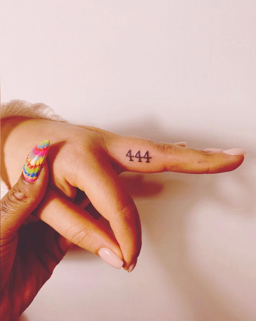 The side of your finger is a great place to get a discrete angel number tattoo.