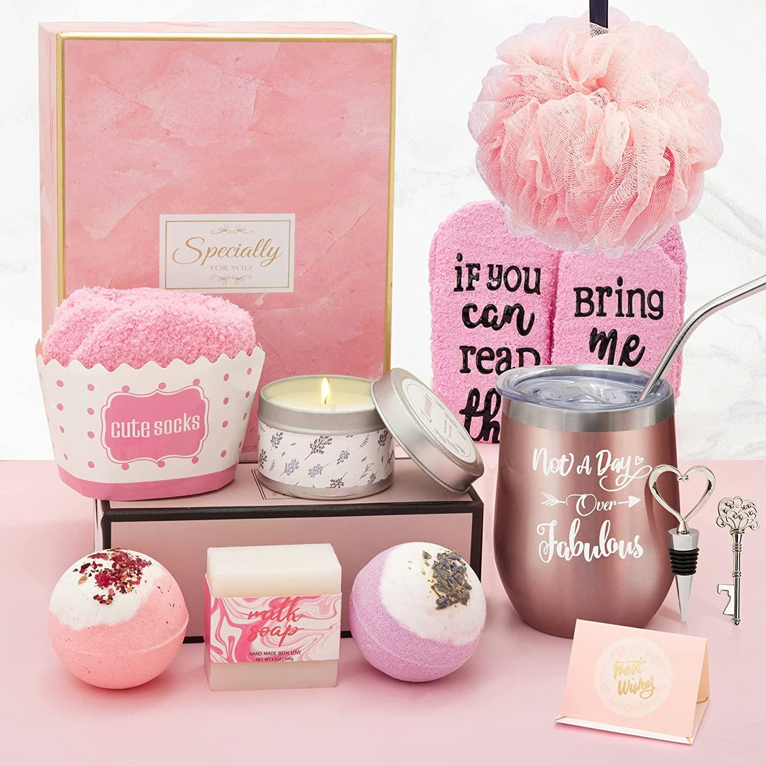 Gift box with bath bombs, wine glass, loofah, socks, and candle