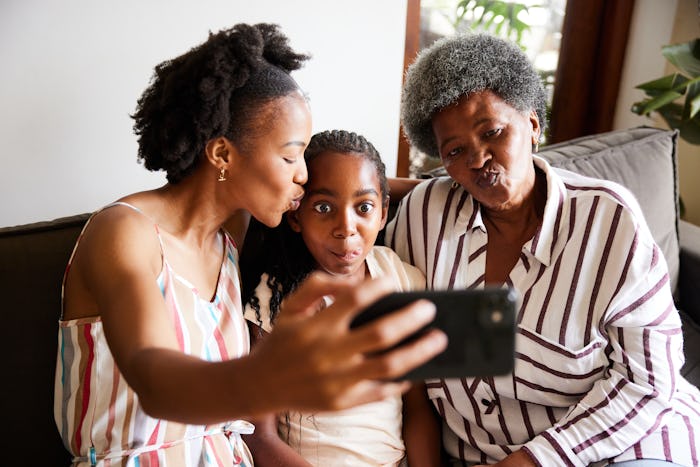 photo of multi-generational family taking a silly selfie goes well with these Mother's Day Hashtags