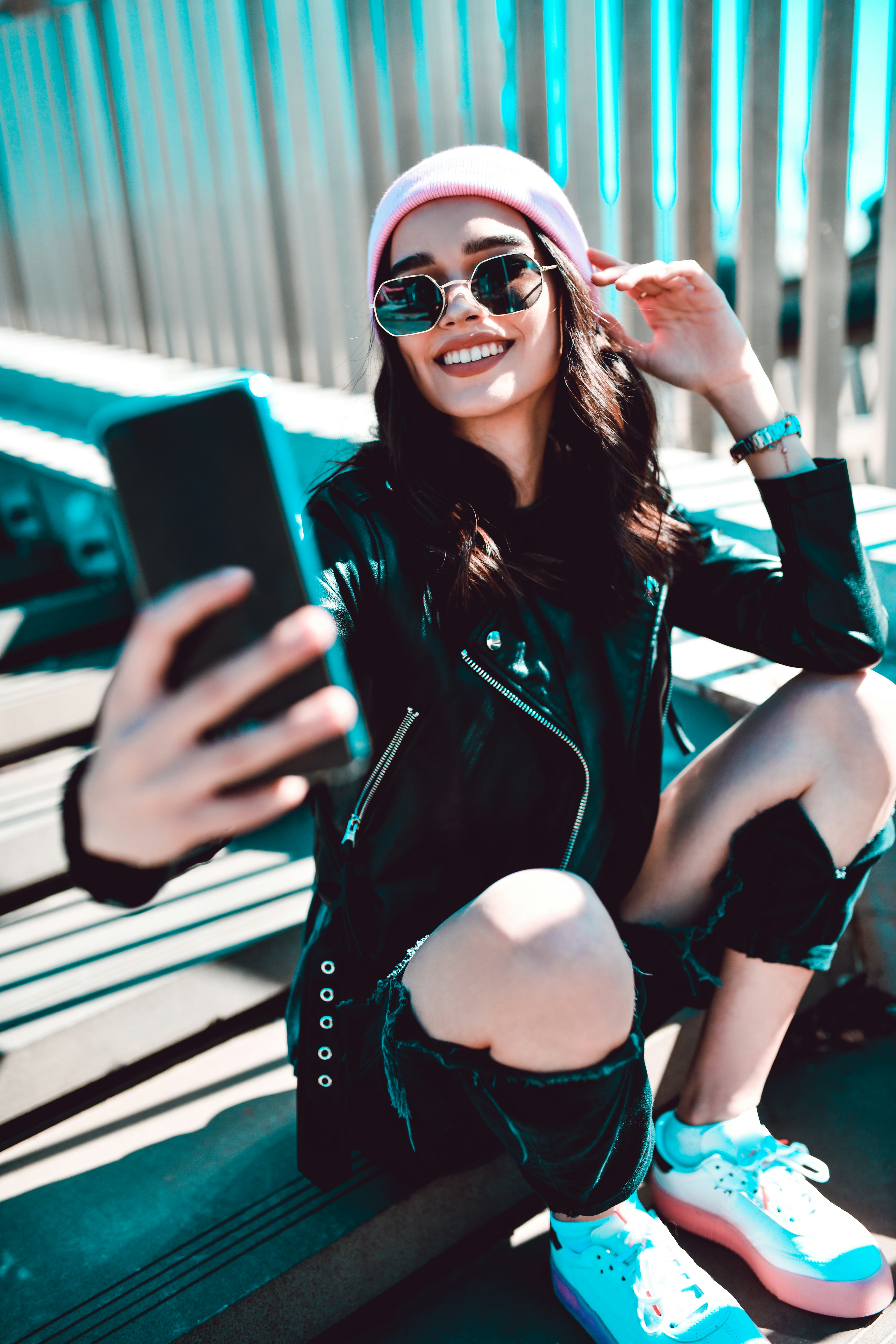 Young woman taking a selfie because her zodiac sign loves being the center of attention.
