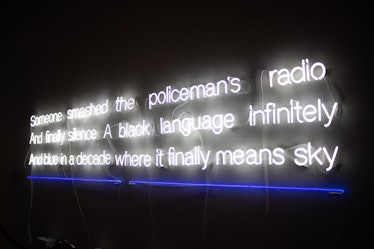 neon sign art that reads Someone smashed the policeman's radio and finally silence a black language ...