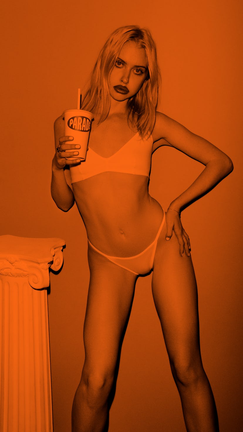 American actress and comedian Chloe Cherry posing in underwear, while holding a cup with a straw