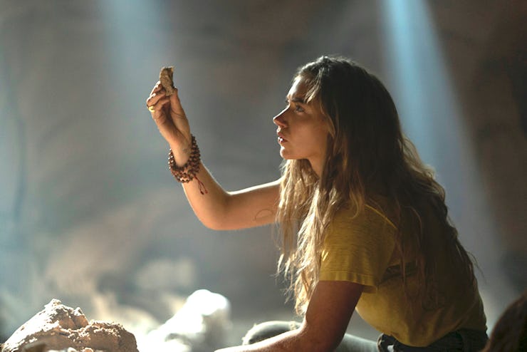 A character on Stranger Things looking at a rock