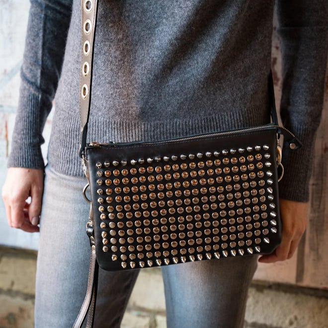 Metallic silver spike and stud hardware gives the classic black bag an edgy, chic upgrade fora. grea...
