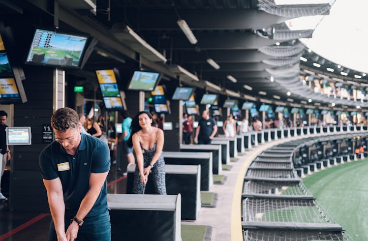 Singles enjoy a TopGolf event as part of Bumble's new IRL program. 