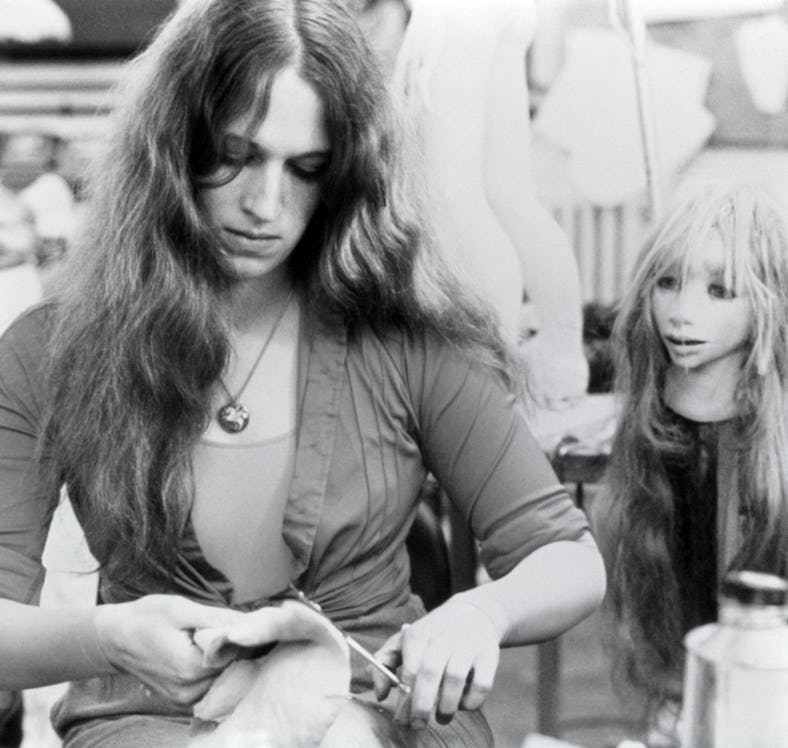 Wendy Froud looking down and tying her shirt