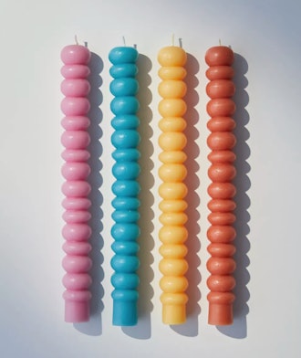 Urban Outfitters bubble taper candle set with pink, blue, yellow, and orange candlesticks