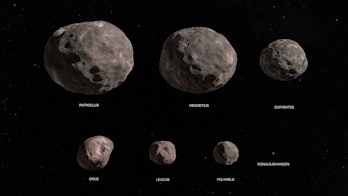 Seven space rocks of different sizes, all round and with the texture of a potato.