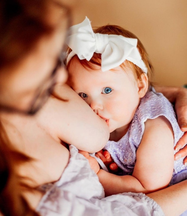 breastfeeding photoshoot ideas of baby looking at camera
