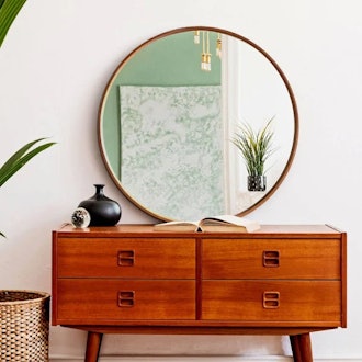 Decorative round wall mirror for placing on top of vanity or dresser, brightening up a room