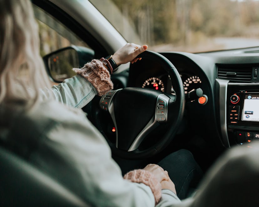 closeup of woman driving car, pain management and alertness are important when driving after a c sec...