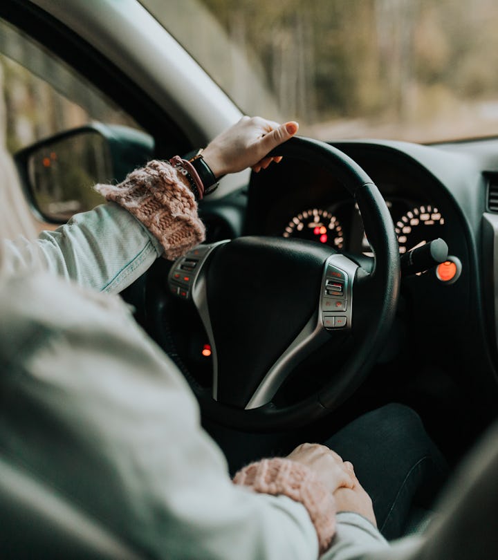 closeup of woman driving car, pain management and alertness are important when driving after a c sec...