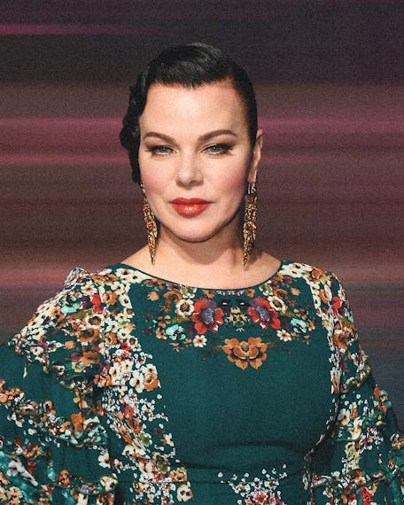 Debi Mazar wearing her hair pulled back and red lipstick