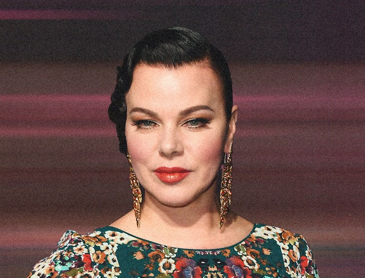 Debi Mazar wearing her hair pulled back and red lipstick