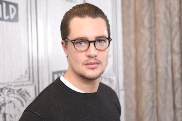 The actor Alexander Dreymon in glasses with slicked back hair. 