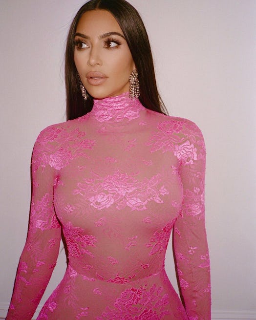 Kim Kardashian in pink lace jumpsuit and chandelier earrings