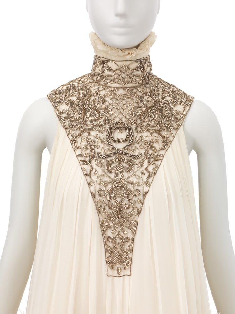 a dress designed by alexander mcqueen with a high ruff collar