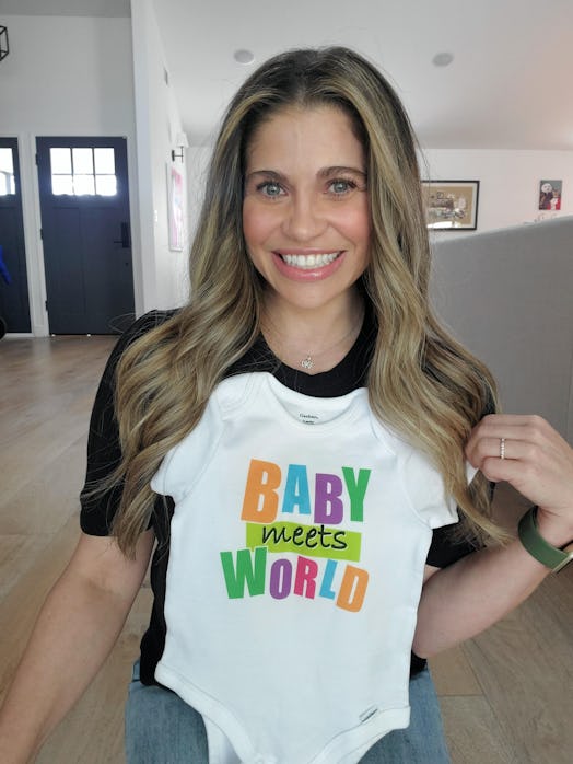 Danielle Fishel poses with a "Baby Meets World" onesie she's giving away on Instagram.