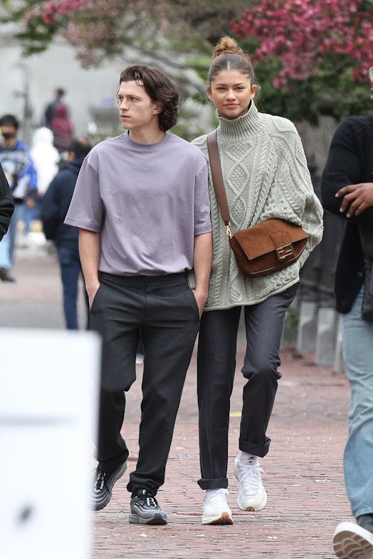 Zendaya carries a brown suede Fendi Baguette bag during a Boston outing.