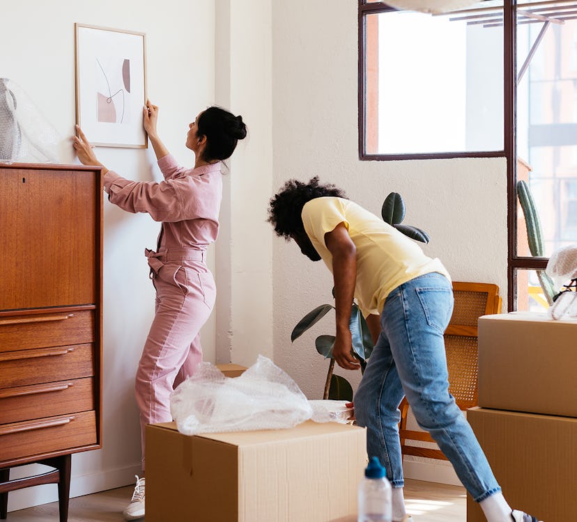 A couple decorating a small room using products to maximize space