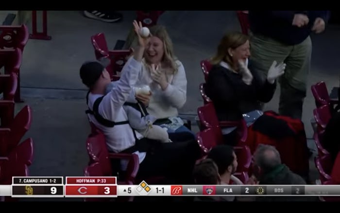 A viral video shows a dad catching foul ball while feeding his baby.